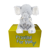 Enzo the gray plush elephant praying toy on a yellow box with 'Praying For You' text.  Christian baby keepsake at sendapraynow.com Enzo the gray plush elephant praying toy on a yellow box with 'Praying For You' text.  Christian baby keepsake at sendapraynow.com